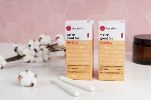 Two boxes of Hey Girls Tampons and cotton plant bolls