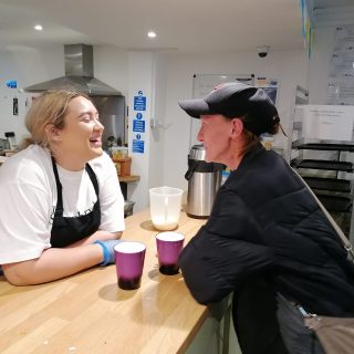 two woman having a pleasant conversation over a cup of tea or coffee